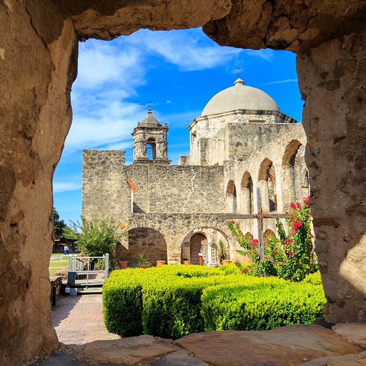 View from a window of the historic Mission San Antonio building in Texas.