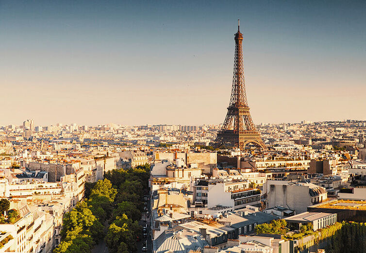  A panoramic view of Paris with the Eiffel Tower standing tall above the cityscape during golden hour,