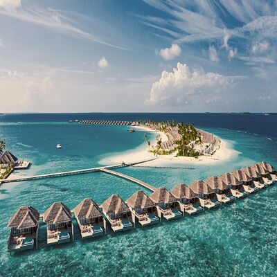  Luxurious resort destination - tropical island with overwater bungalows extending into the turquoise sea