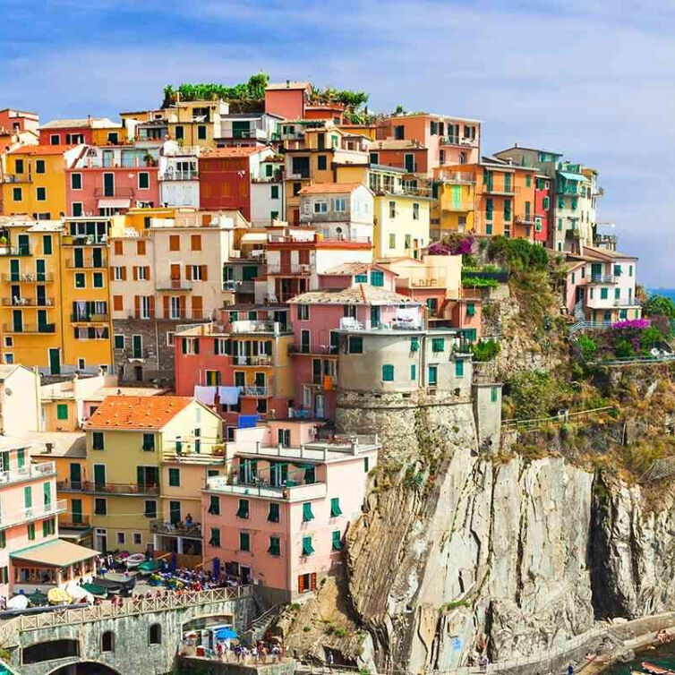 A picturesque view of the colorful cliffside houses of Manarola, one of the Cinque Terre villages in Italy
