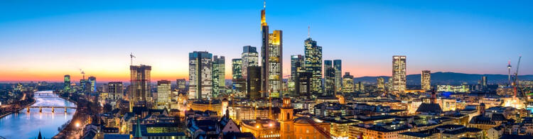 Impressive skyline of Frankfurt, Germany, illuminated by the lights of the city at night.