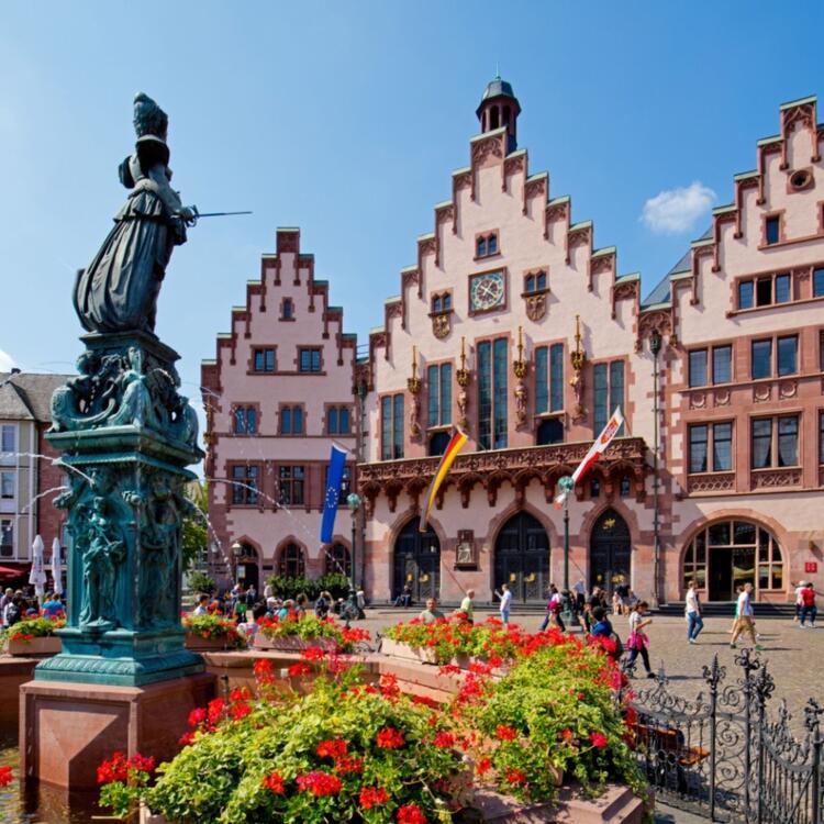 A picturesque view of the red facade and intricate details of the historic Rathaus am Römer in Frankfurt