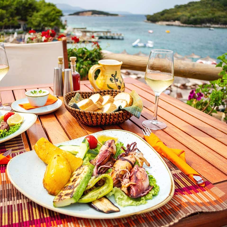 Gegrillte Meeresfrüchte mit Gemüse und Zitrone auf dem Tisch in der Strandpromenade