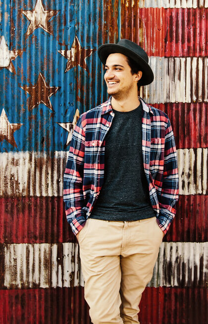 Young man in front of a US flag