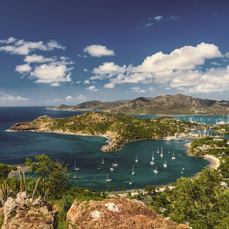 Panoramic view from Shirley Heights overlooking English Harbour in Antigua and Barbuda, with scattered sailboats in the calm sea