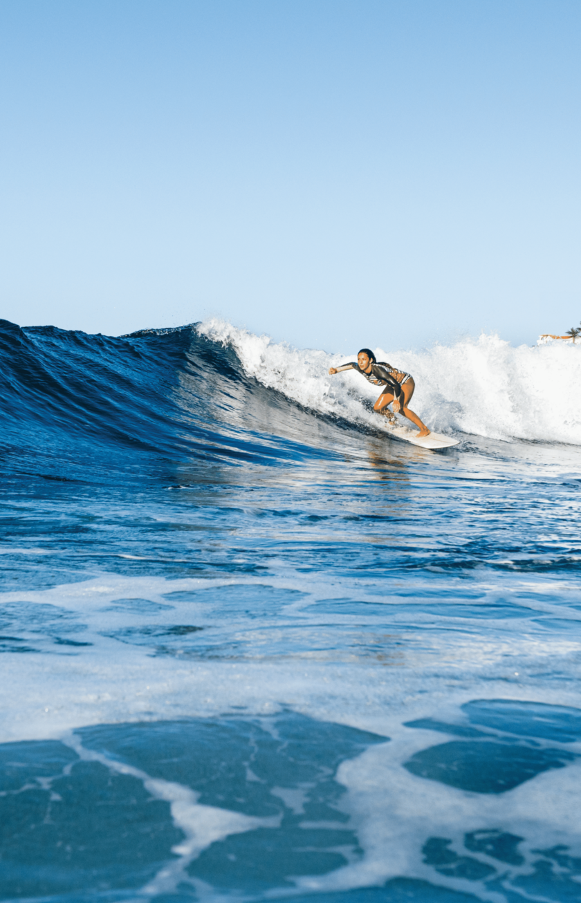 A woman surfs waves in Tenerife