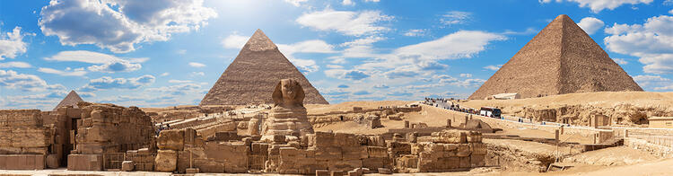 Sphinx and pyramids of Giza against blue sky