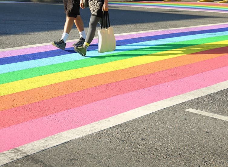 A closeup of a crosswalk in rainbow colors honoring the LGBTQI+ community in Vancouver.