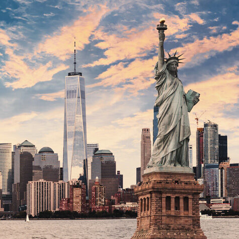 The famous statue of liberty with the New York Skyline in the background