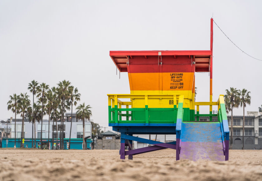 Lifeguard station on Santa Monica beach with palm trees in the background