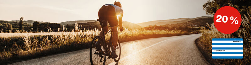 20% discount on Activity Card promotion with a red circle and the blue and white striped Activity Card; a man on a mountainbike during the sunset