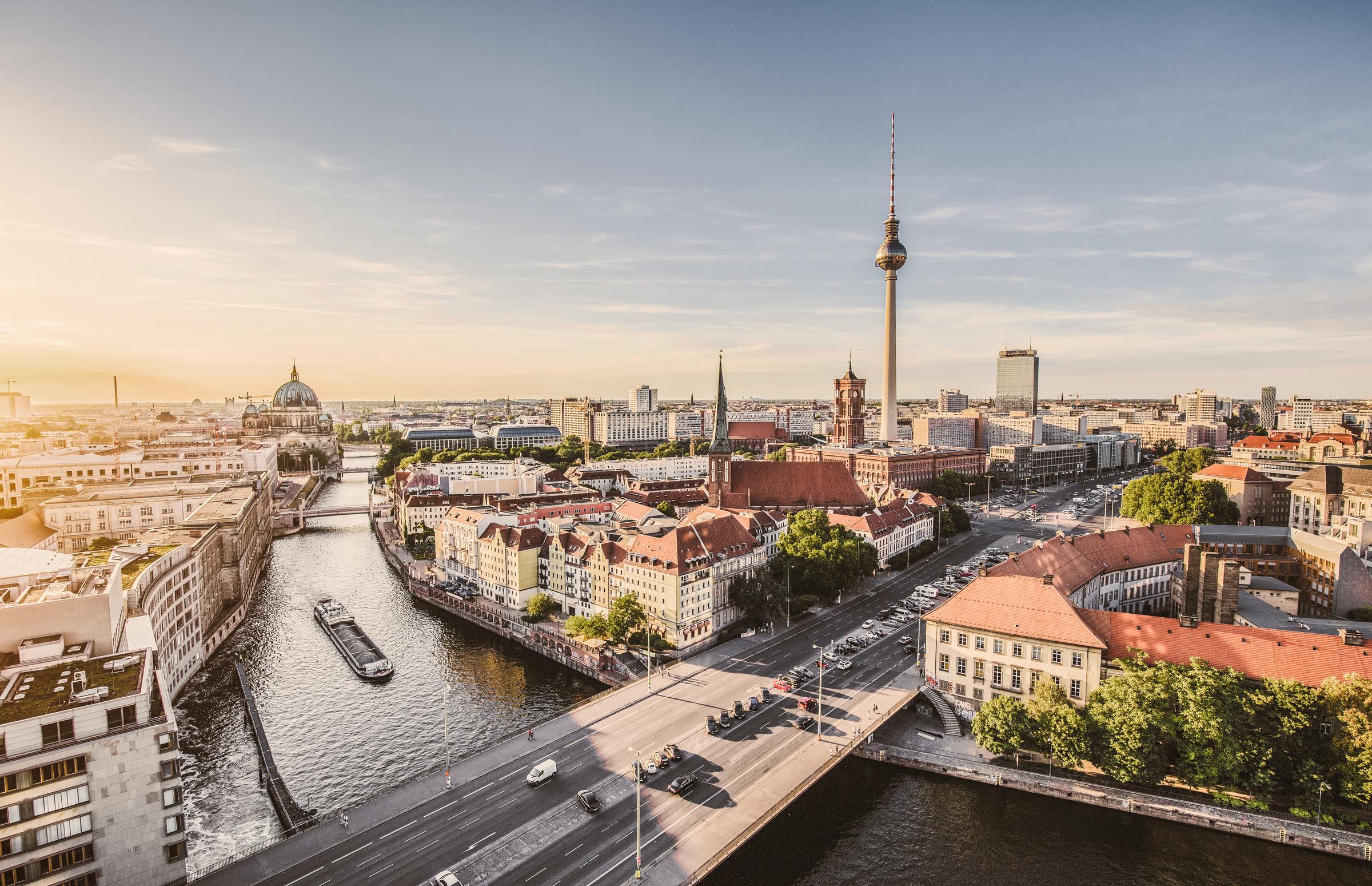 Aerial view of Berlin skyline with famous TV tower and Spree in beautiful evening light at sunset with retro vintage Instagram-style grunge pastel-tinted filter effect.