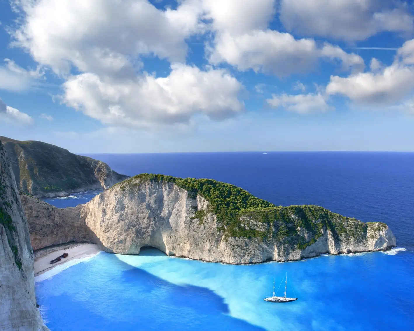 Beach in Zakynthos with blue water and boat
