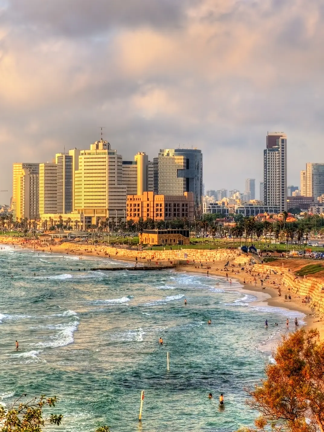 Beach promenade in Tel Aviv with sunset und skyline