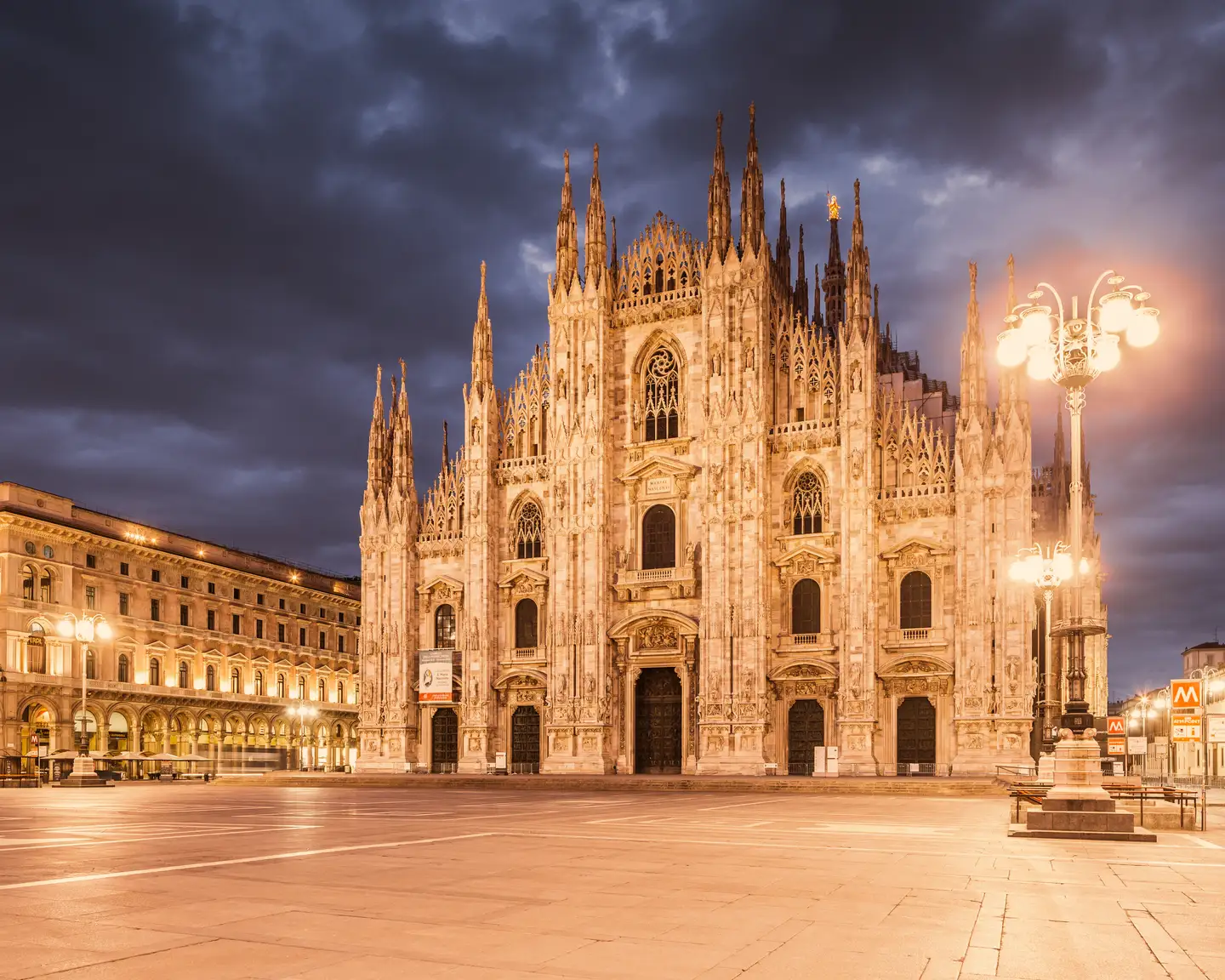 Milan Cathedral at dusk with illuminated square