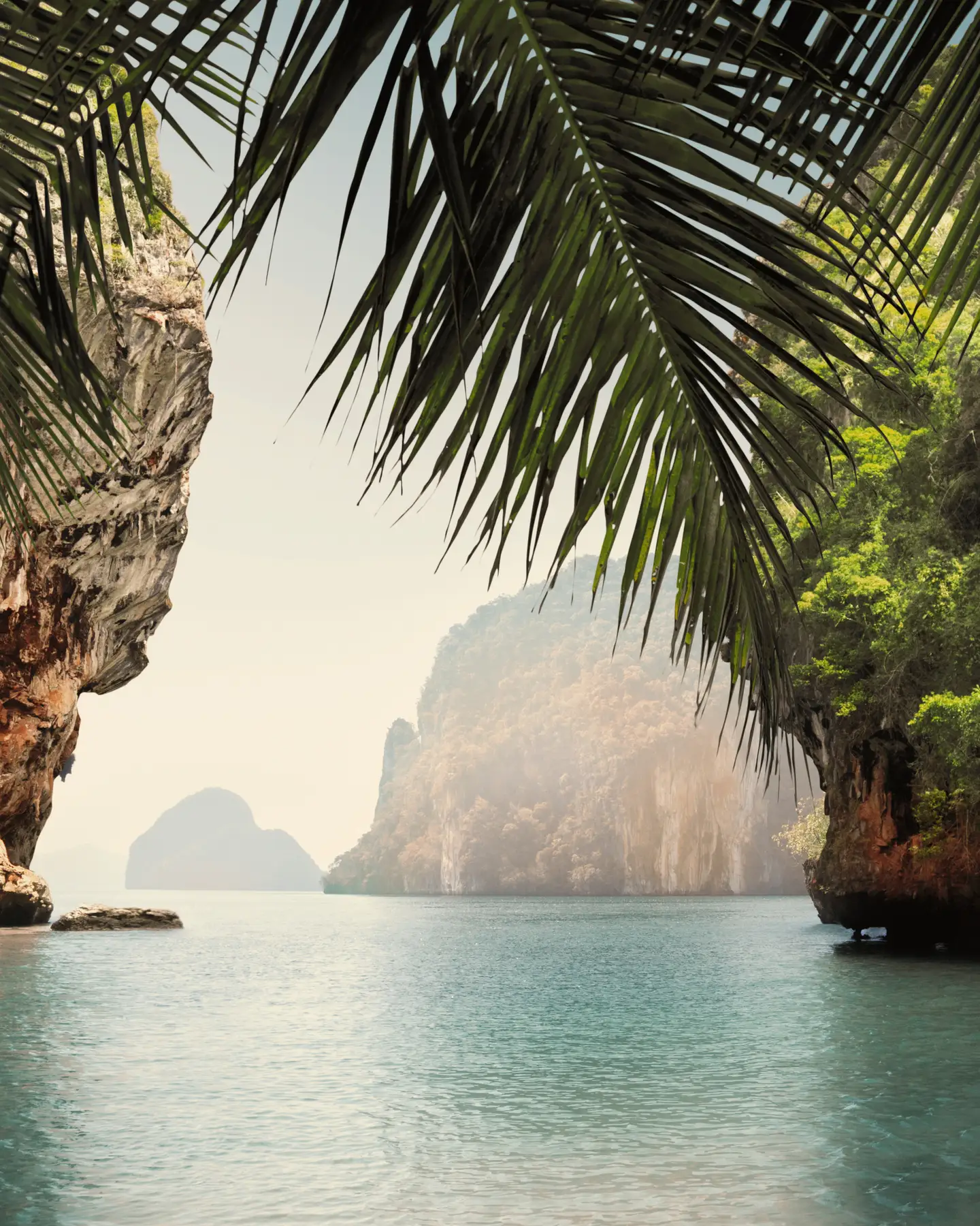 The breathtaking bay of Khao Phing Kan, Thailand, surrounded by high limestone cliffs and lush vegetation.