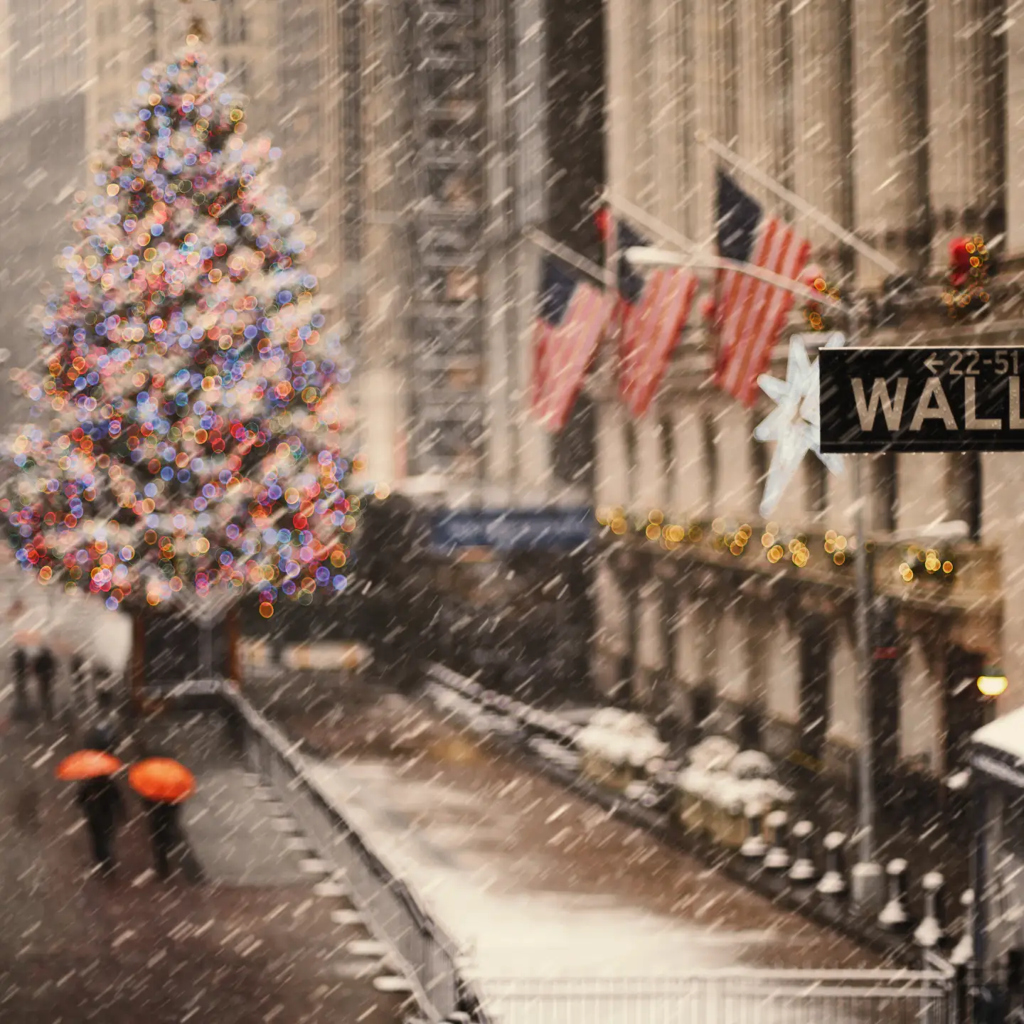 View of Wall Street in New York with a lit-up Christmas tree in the snow during the holiday season,