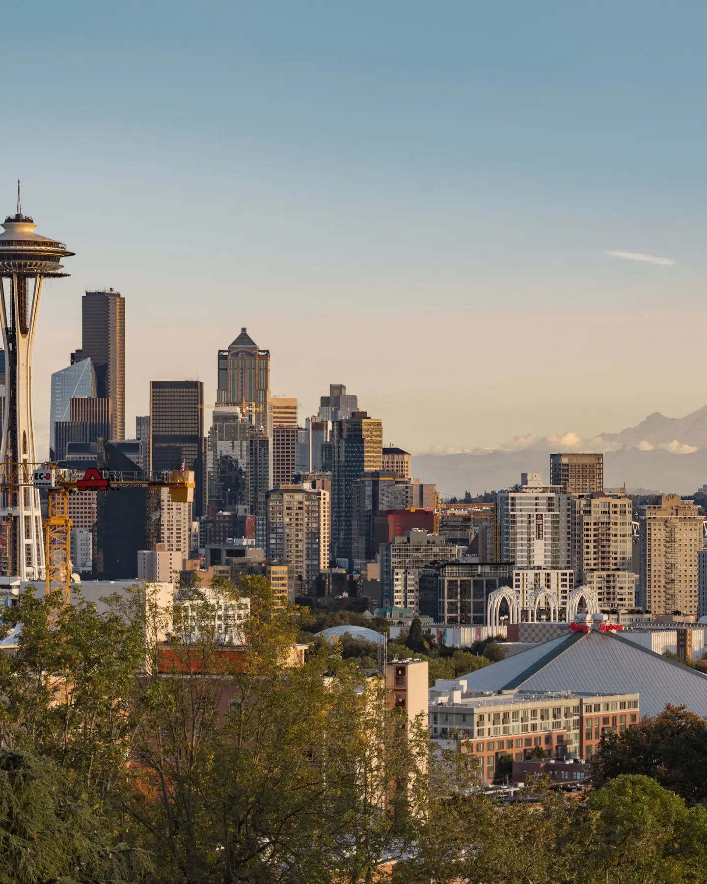 View of the skyline of Seattle, Washington, with the Space Needle in the foreground and Mount Rainier in the background.