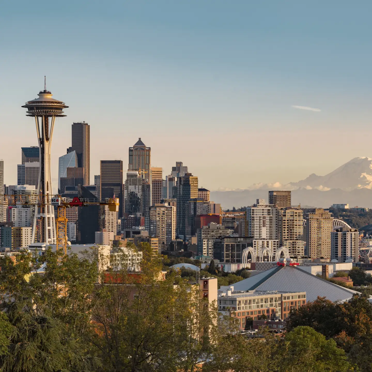 View of the skyline of Seattle, Washington, with the Space Needle in the foreground and Mount Rainier in the background.
