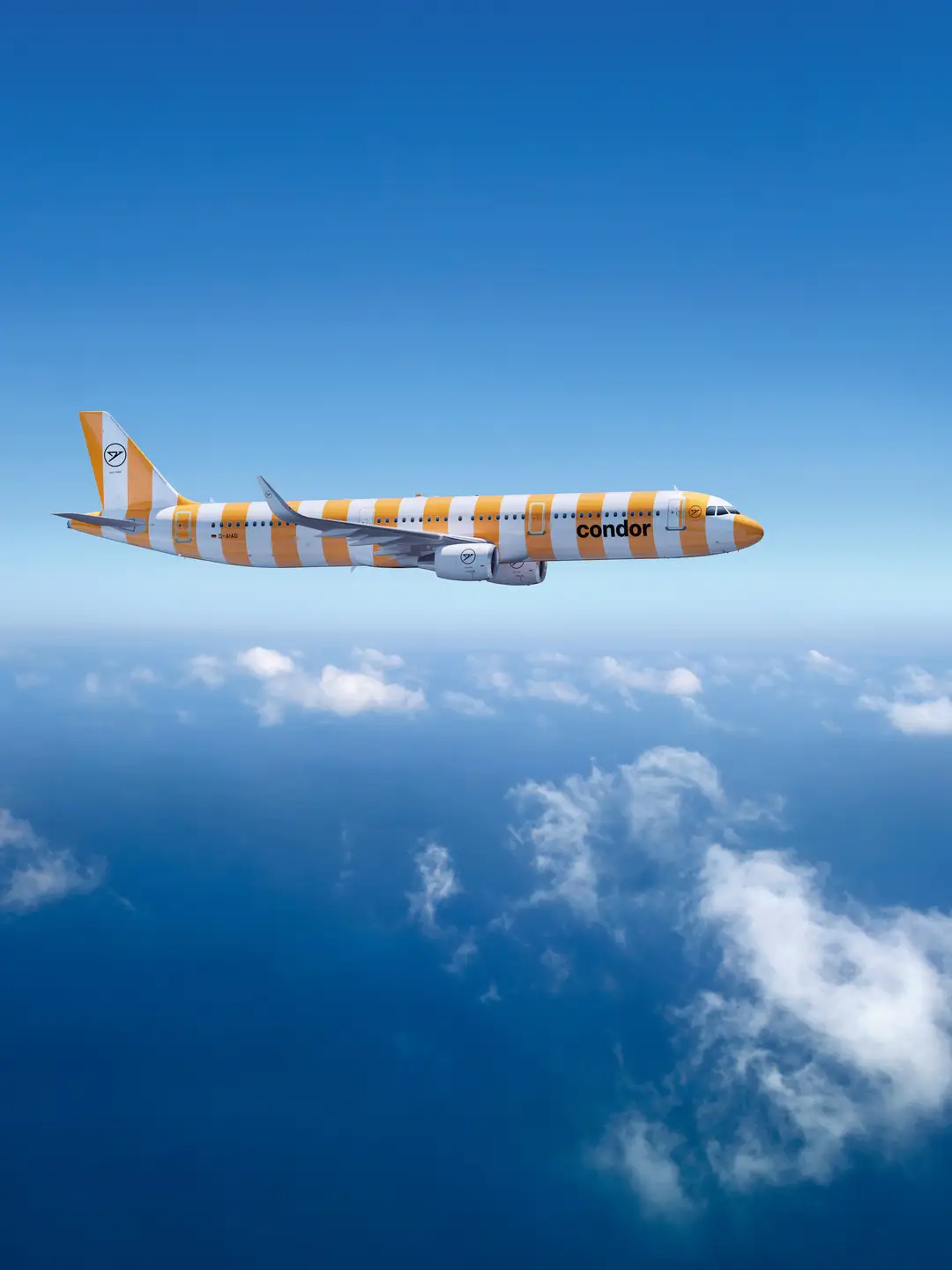 Un Airbus A321-200 de Condor de color Sunshine sobre un cielo azul claro, con finas nubes blancas debajo.