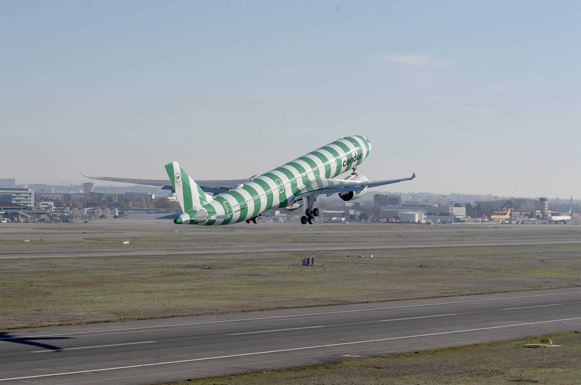 Airbus A330neo in green and white stripes at take-off