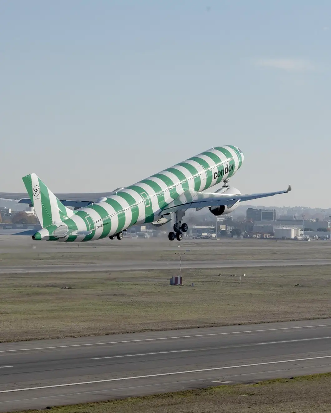 Airbus A330neo in green and white stripes at take-off