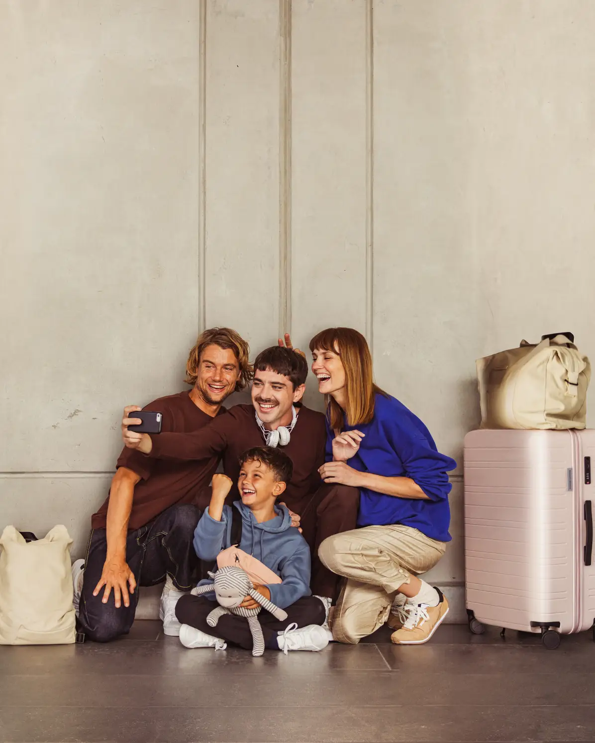 A small group of travelers laughing and taking a selfie