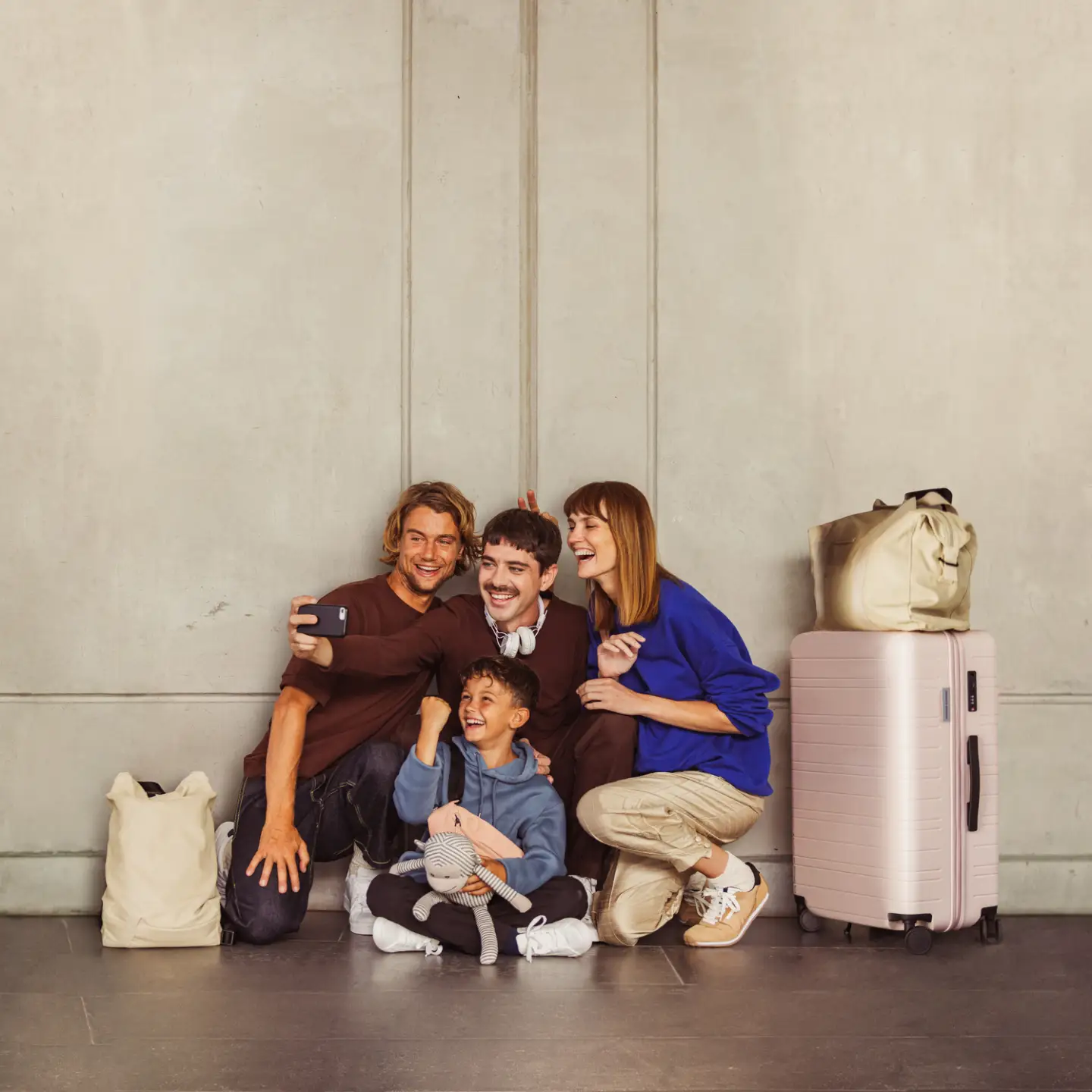 A small group of travelers laughing and taking a selfie