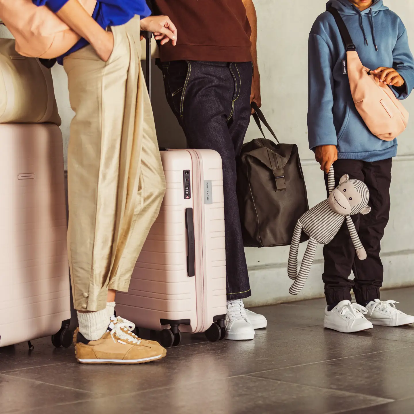A group of people standing with their baggage at the airport.