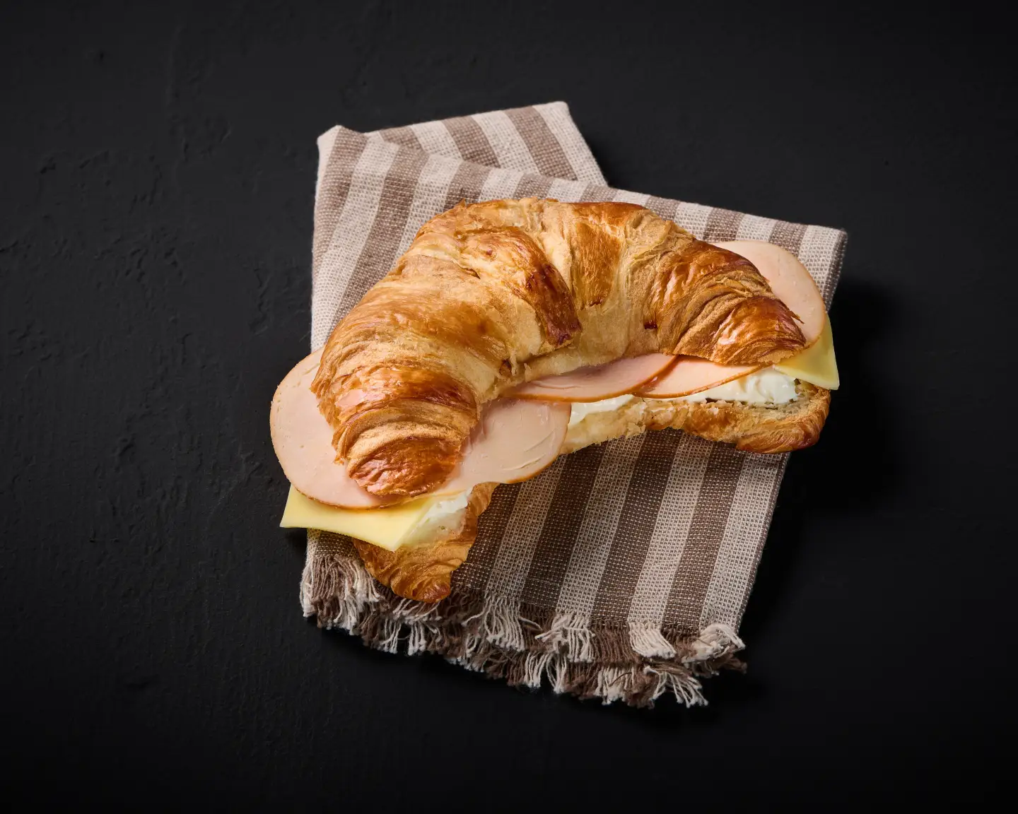 Croissant topped with chicken and cheese