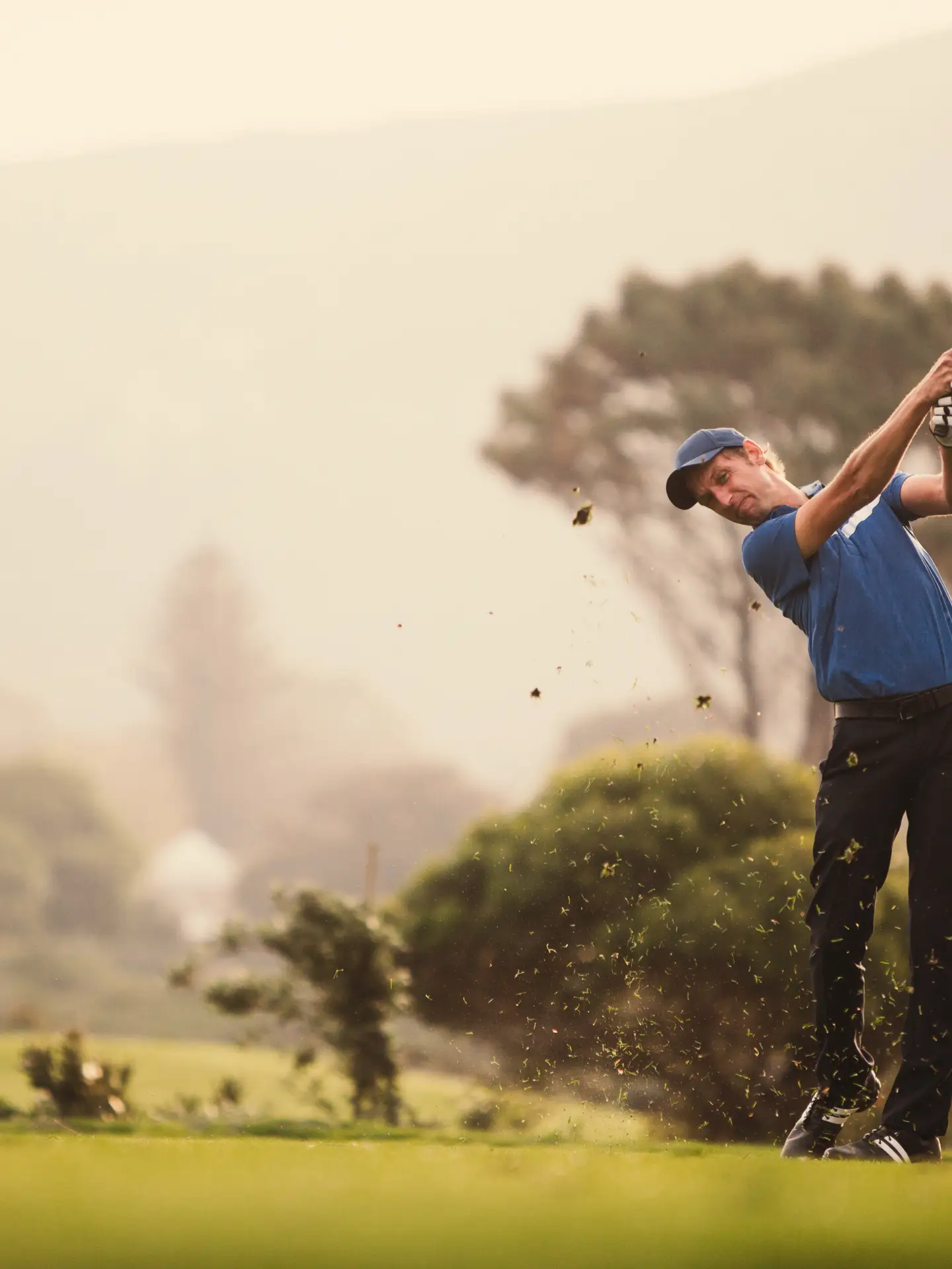 A young male golfer swings his driver for his t-shot.