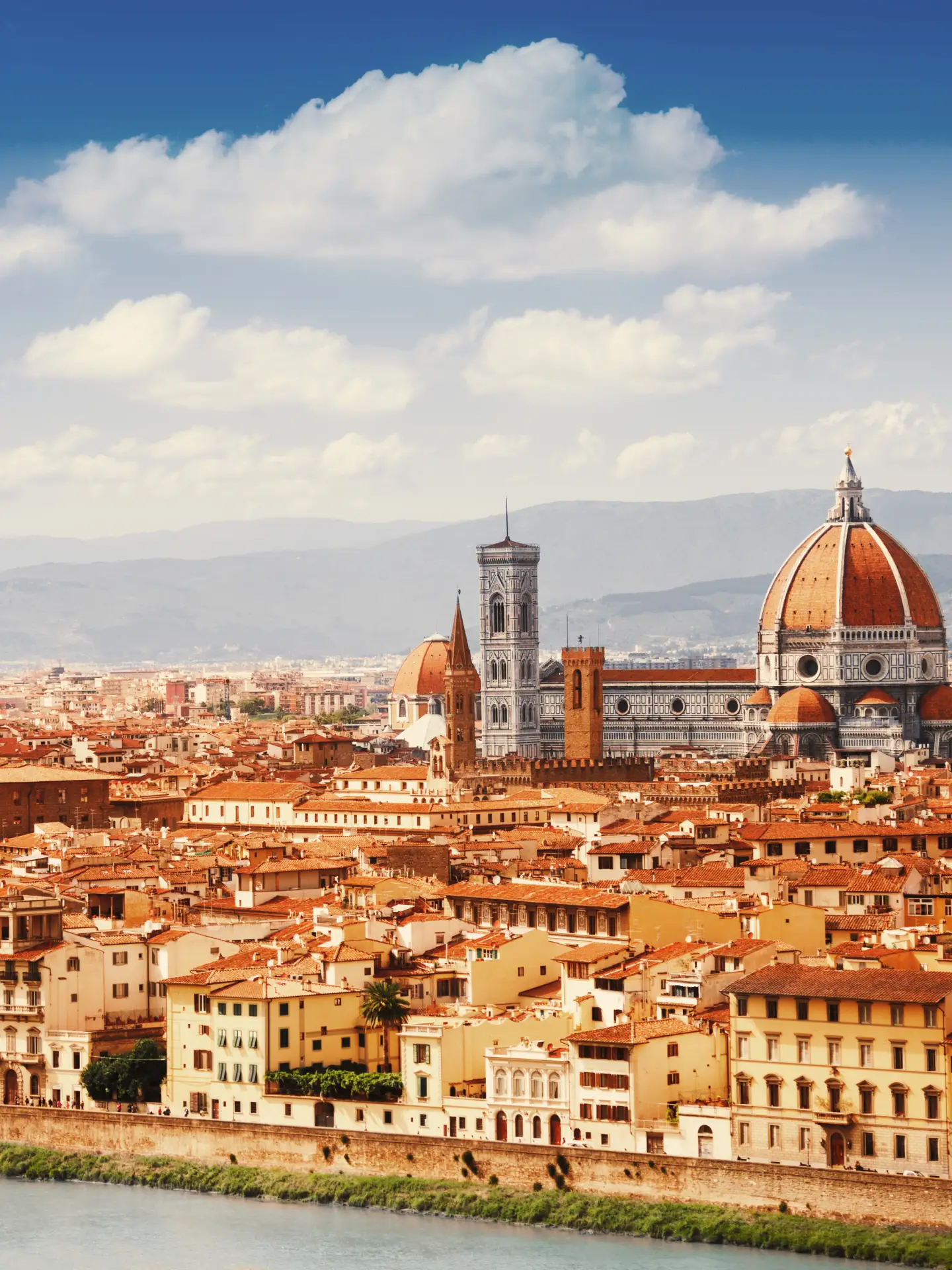 Panoramic view of Florence’s skyline with the Cathedral of Santa Maria del Fiore, historic buildings and the hills of Tuscany in the background.