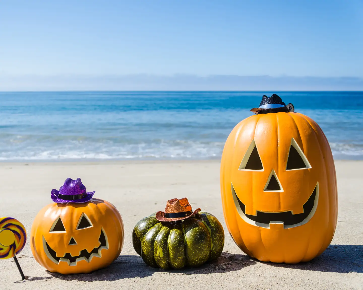 Ocean Happy Halloween background with three pumpkins and candy