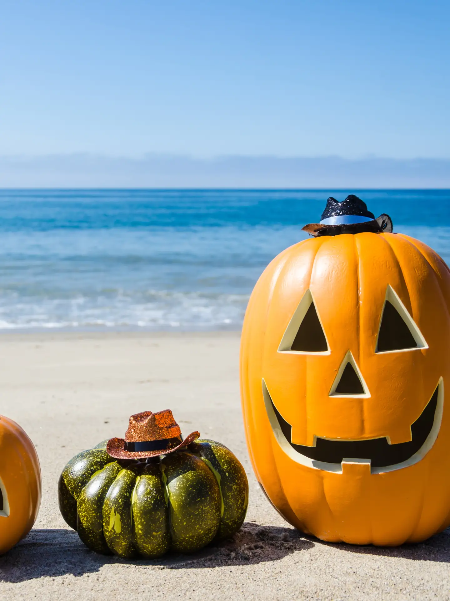 Ocean Happy Halloween background with three pumpkins and candy