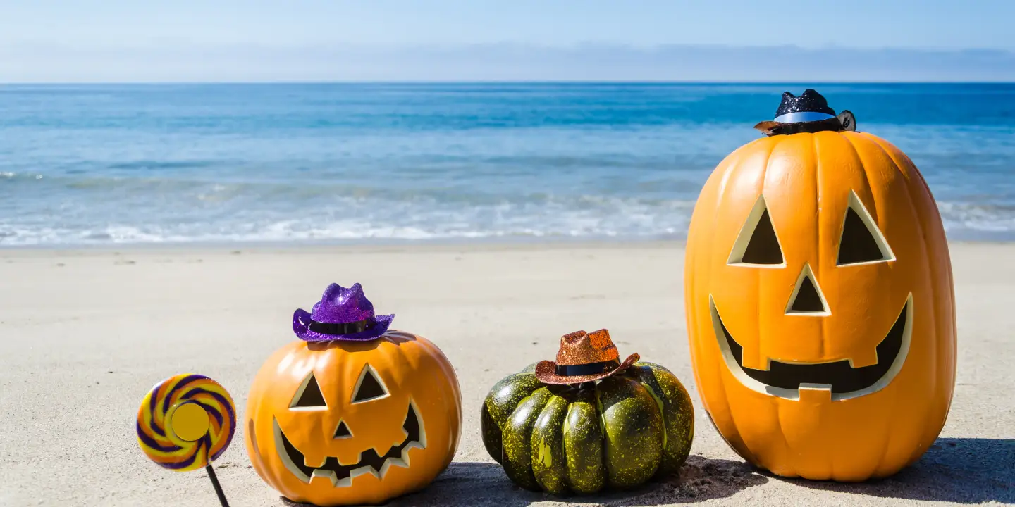 Ocean Happy Halloween background with three pumpkins and candy