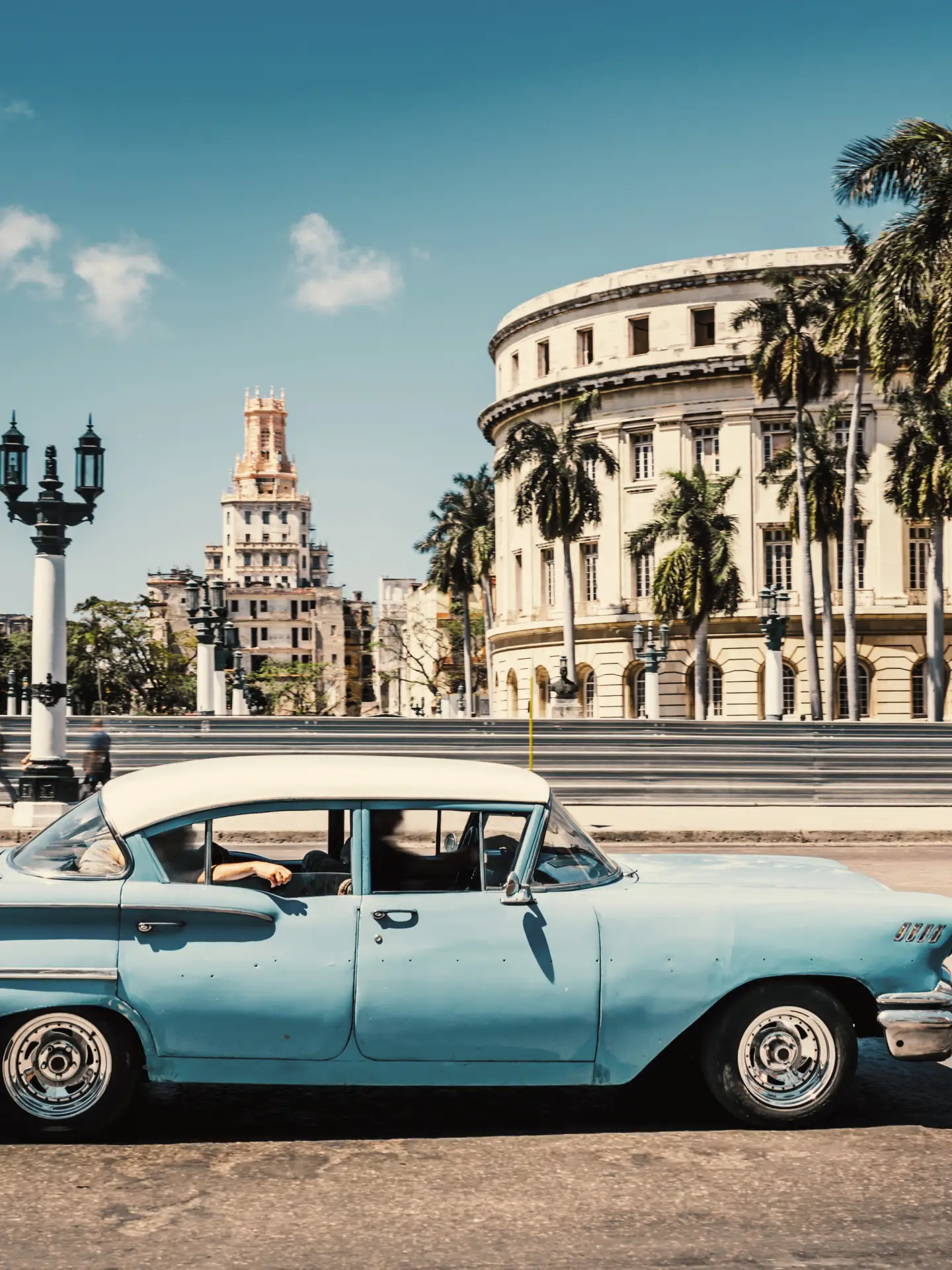 Old American car driving at a street of old Havana, Cuba