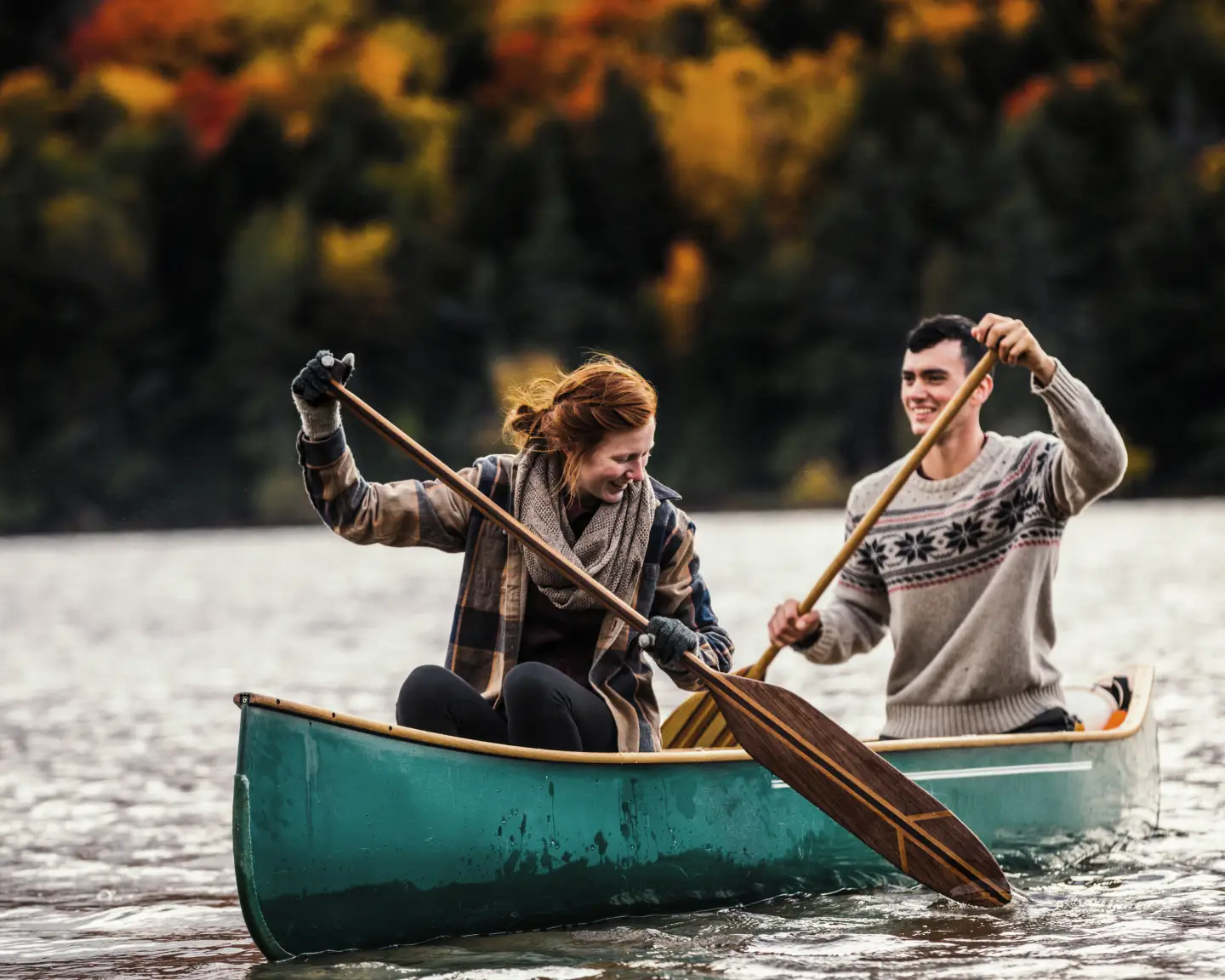 Couple enjoying a ride on a typical canoe in the Algonquin Park, Ontario - Canada.