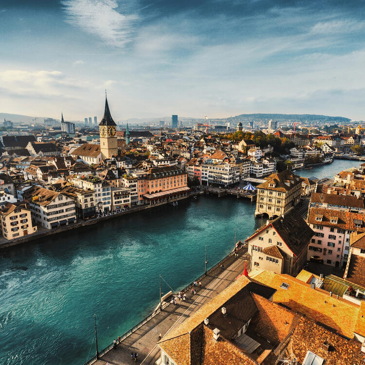 View of the Limmat river as it flows through Zurich, the city and its bridges