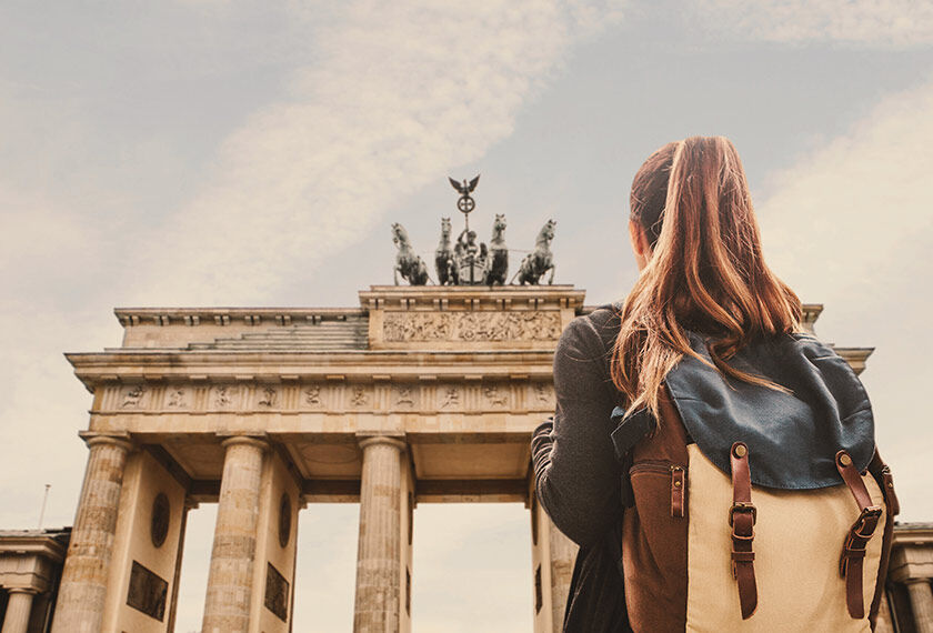 Back view of a girl in front of the Brandenburg Gate in Berlin