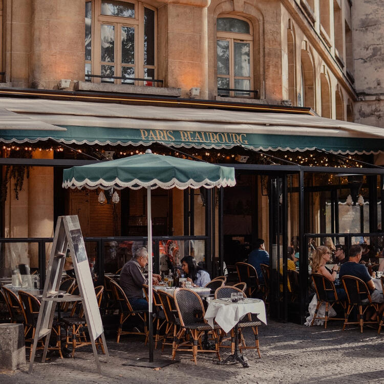 Diners enjoy a meal at the Paris restaurant with its traditional Parisian café ambiance.