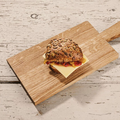 Freshly baked multigrain roll with cheese and grilled vegetables