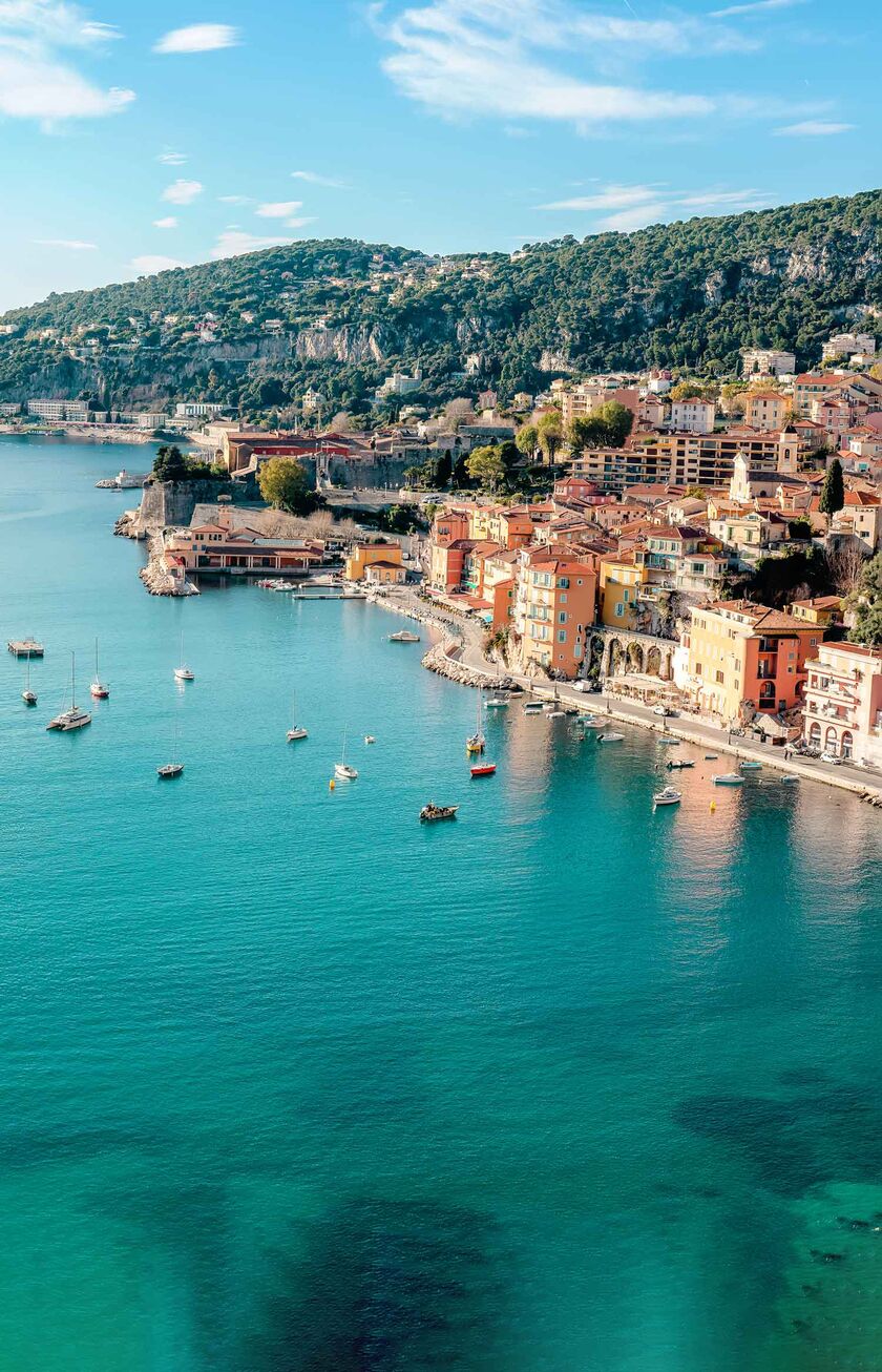 A stunning landscape foto of the French Riviera with picturesque colorful houses on the blue coastline.