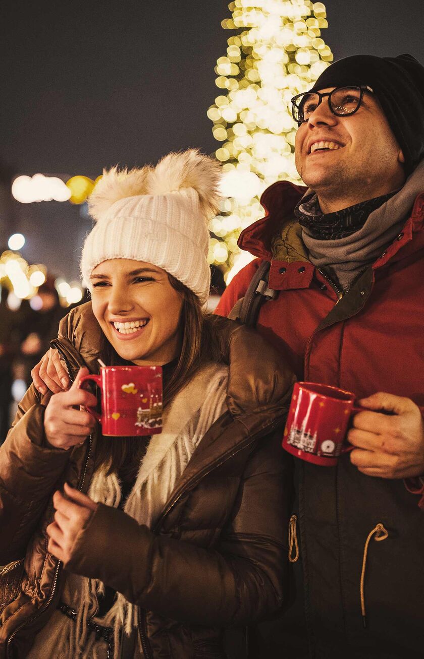 a couple enjoying the traditional christmas market in Vienna, Austria
