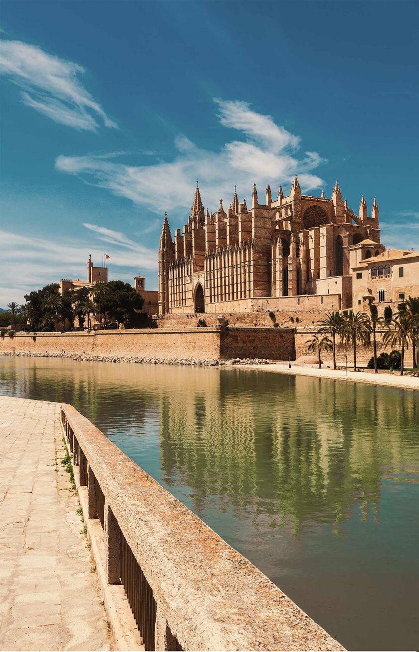 The famous cathedral in Palma with blue sky and the famous pond in front of the picture