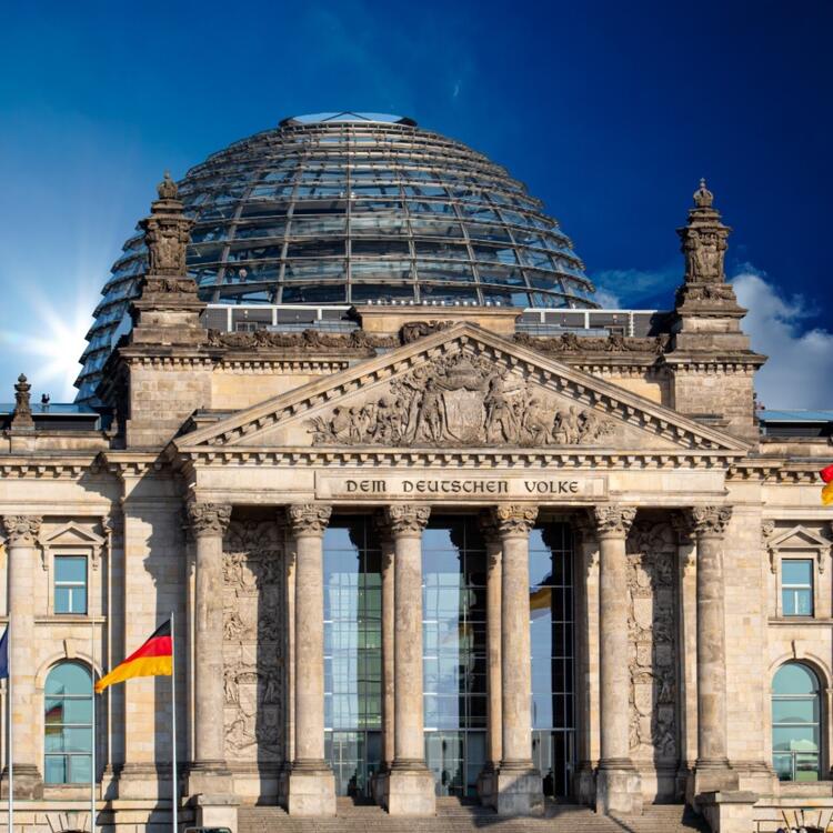 The Reichstag building and its glass dome on a beatiful day with sunshine and blue sky 
