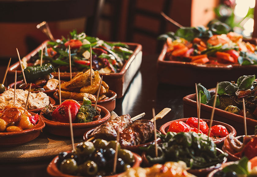 Spanish Tapas Close-up of a variety of colorful Spanish tapas served on a rustic tray