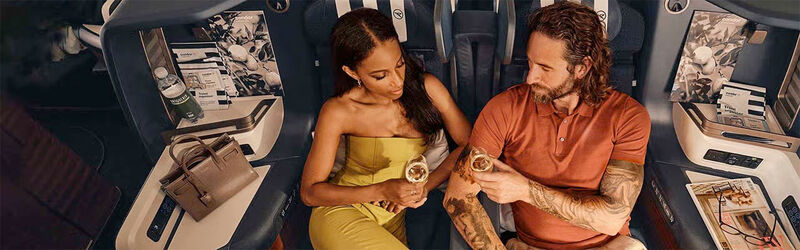 Condor Upgrade A couple enjoying a drink in Condor's Prime Seats in Business Class