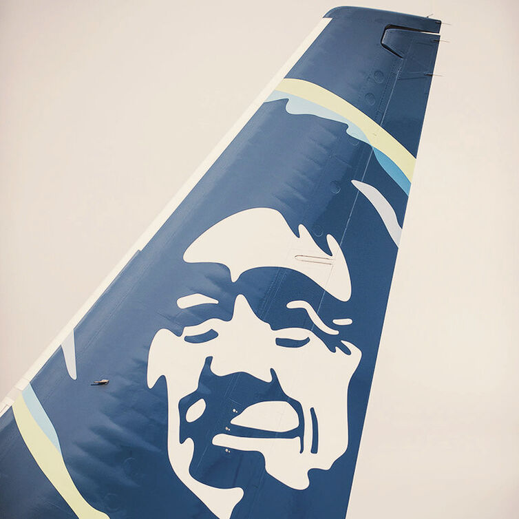 View of the tail of an Alaska Airlines aircraft.