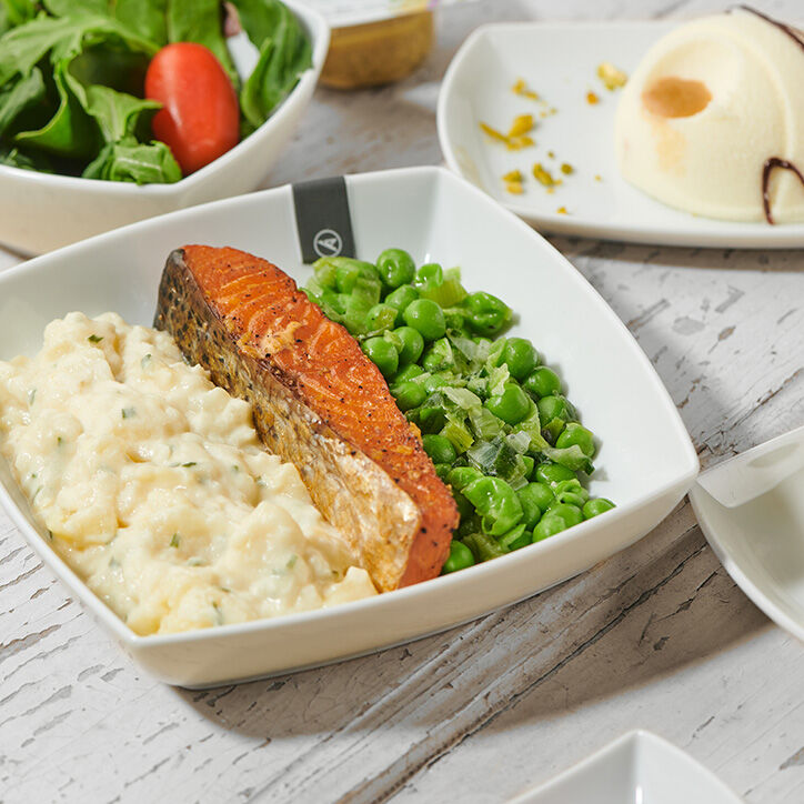 Menu consisting of salmon, rice and vegetables on a long-haul Condor flight