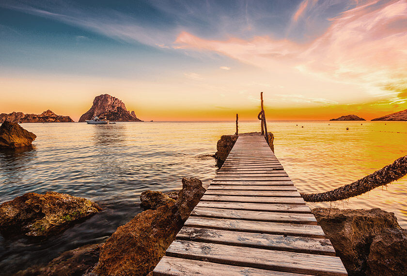 Festivals in Ibiza (IBZ) Awesone view of the sunset over the Mediterranean Sea from a pier in Ibiza, Spain